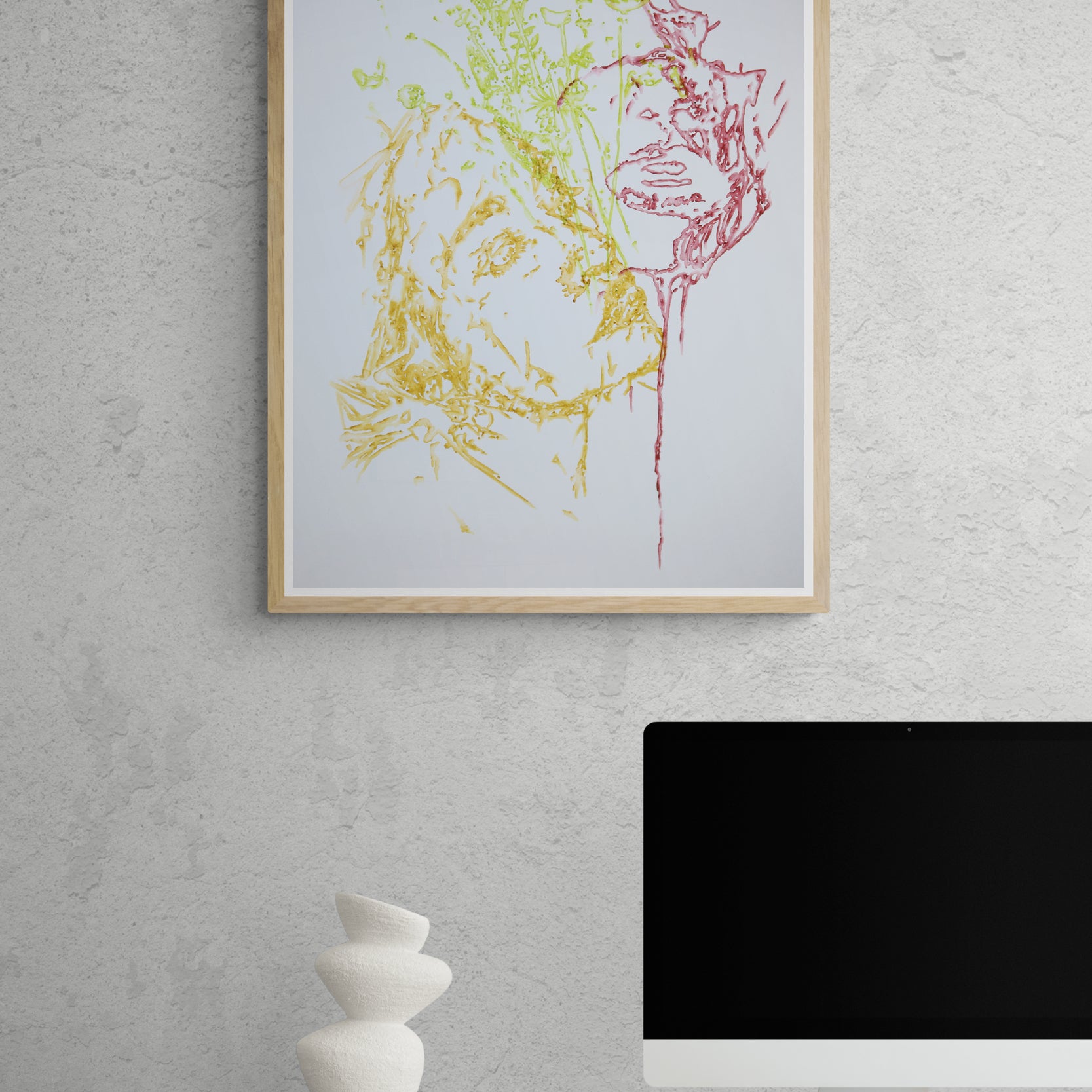 Œuvre de la collection Métamorphe encadrée, aquarelle sur papier, motif de visages entourés de feuillage, au rendu délicat, présentée en intérieur.